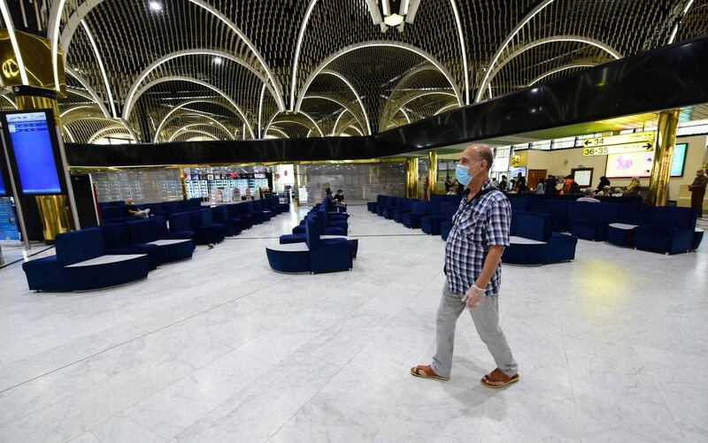 An Iraqi man wears a protective mask as he walks around Baghdad international Airport.  EPA