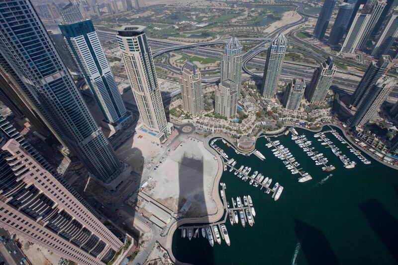 Dubai, United Arab Emirates - June 11 2013 - The shadow of the Cayan Tower is seen along the Dubai Marina view from the 72nd floor penthouse apartment at the Cayan Tower in the Dubai Marina.  (Razan Alzayani / The National)