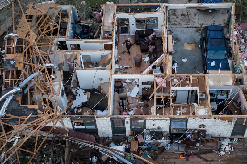A woman walks through a destroyed home following a tornado in Round Rock, Texas, US. Reuters