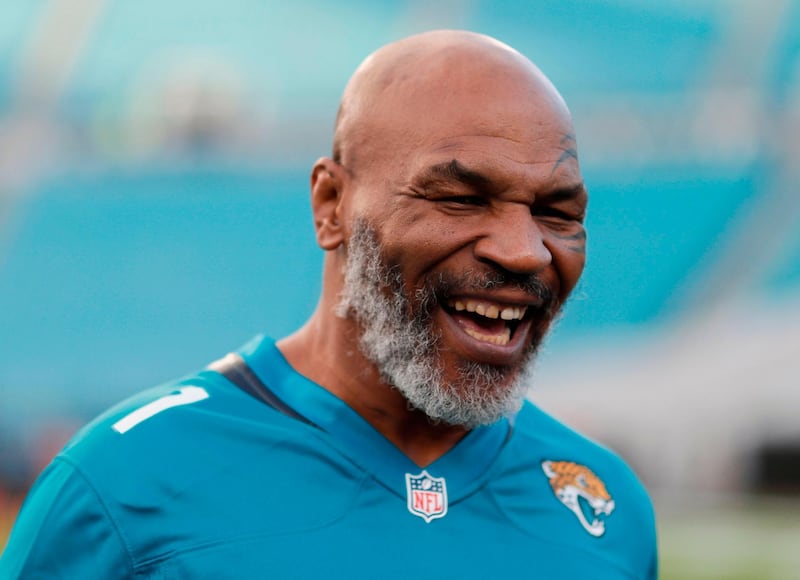 (FILES) In this file photo taken on September 19, 2019, former world heavyweight champion Mike Tyson before the start of the Tennessee Titans at Jacksonville Jaguars in Jacksonville, Florida.    Tyson, who retired in 2005, said on July 23, 2020, he will make a comeback at age 54, fighting Roy Jones Jr. on September 12 in Los Angeles. On his Legends Only League website, Tyson announced the bout against Jones, a 51-year-old fighter who briefly held the heavyweight title and has fought consistently into his 50s. "It's just going to be amazing," Tyson said. / AFP / GETTY IMAGES NORTH AMERICA / James Gilbert

