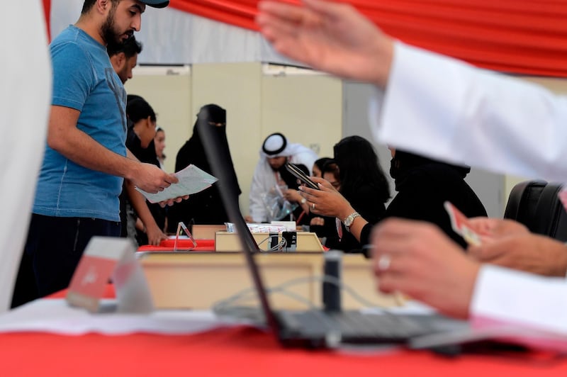 Bahraini voters queue at a polling station in the Bahraini city of Al-Muharraq. AFP