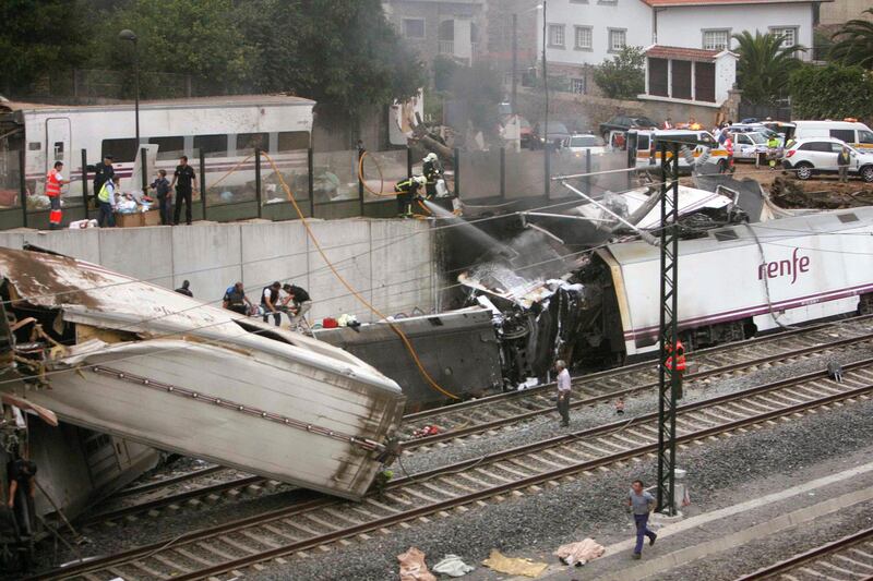 Emergency personnel respond to the scene of a train derailment in Santiago de Compostela, Spain, Wednesday, July 24, 2013. A train derailed in northwestern Spain on Wednesday night, toppling passenger cars on their sides and leaving at least one torn open as smoke rose into the air. Dozens were feared dead, with possibly even more injured. (AP Photo/ El correo Gallego/Antonio Hernandez) *** Local Caption ***  Spain Train Derailment.JPEG-0c341.jpg