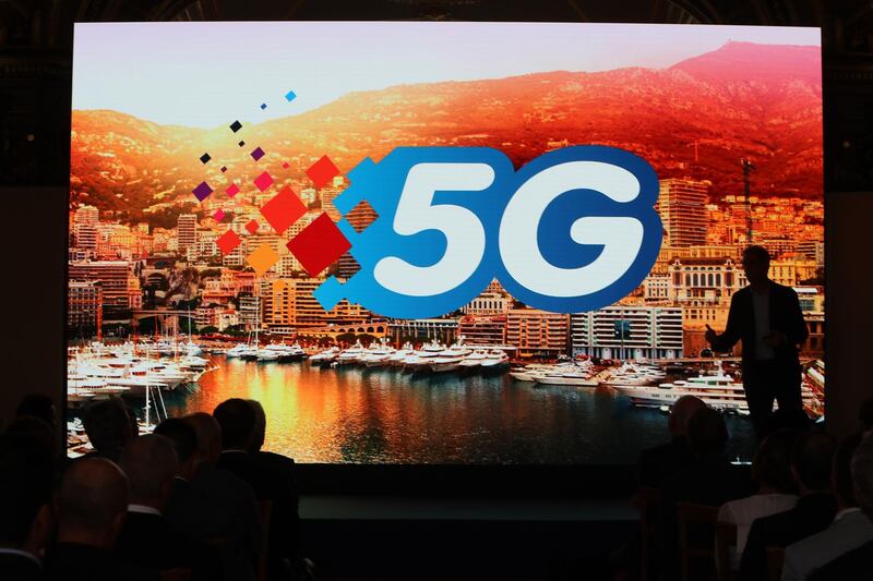 People attend an event to officially announce the achievement of full 5G coverage in Monaco on July 9, 2019. / AFP / VALERY HACHE
