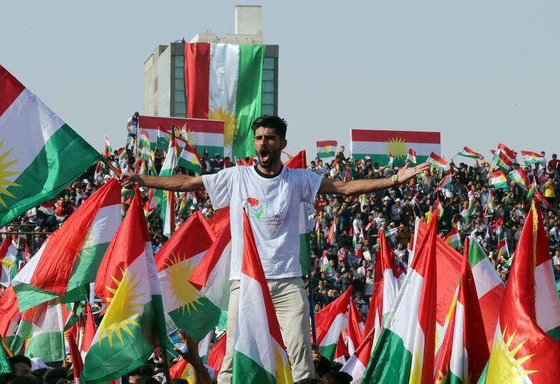 epa06220267 A Kurd holds Kurdish flags during a rally for the Kurdistan independence referendum campaign at the Franso Hariri stadium in Erbil, Iraq, 22 September 2017. The Kurdistan region is an autonomous region in northern Iraq since 1991, with an estimated population of 5.3 million people. The region share borders with Turkey, Iran, and Syria, all of which have large Kurdish minorities. On 25 September the Kurdistan region will hold a referendum for independence and the creation of the state of Kurdistan amidst divided international support.  EPA/MOHAMED MESSARA