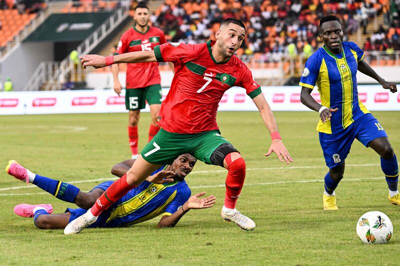 Morocco midfielder Hakim Ziyech shrigs off a challenge from Tanzania defender Ibrahim Hamad. AFP