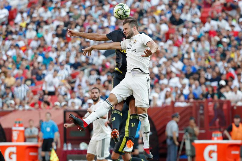 Real Madrid's Nacho leaps to head the ball in front of Juventus' Giorgio Chiellini. Reuters