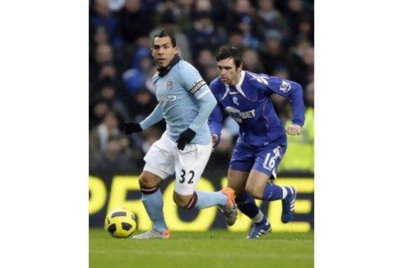 A fourth-minute goal from Carlos Tevez, left, the Argentine striker, was enough to earn Manchester City all three points at home to Bolton Wanderers yesterday. 

Jon Super / AP Photo