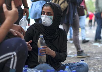 Fatima Imad prepares a mixture of yeast and water to treat protesters affected by tear gas. Pesha Magid for The National