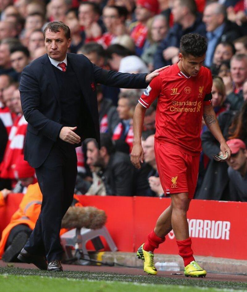 Liverpool Manager Brendan Rodgers, left, congratulates Philippe Coutinho as he is substituted during their Premier League match against Manchester City at Anfield on April 13, 2014 in Liverpool, England. Alex Livesey/Getty Images