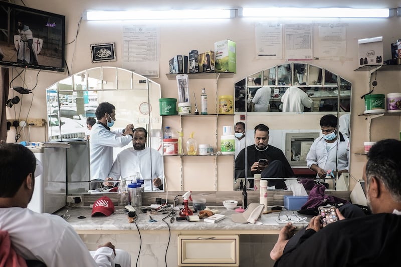 Men at a barbershop in the city of Khor Fakkan, Sharjah. EPA