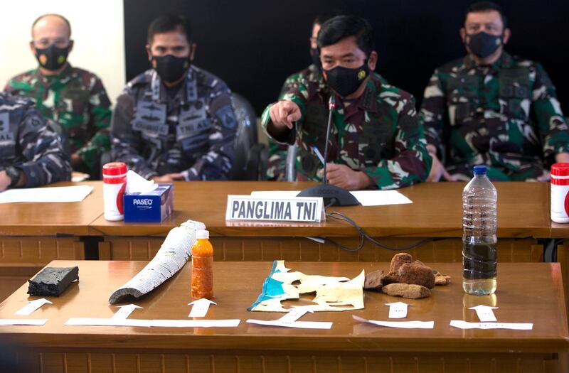 Indonesian Military chief Hadi Tjahjanto, center, talks to media as they show debris found in the waters during a search operation for the Indonesian Navy submarine KRI Nanggala at Ngurah Rai Military Air Base in Bali, Indonesia. AP Photo