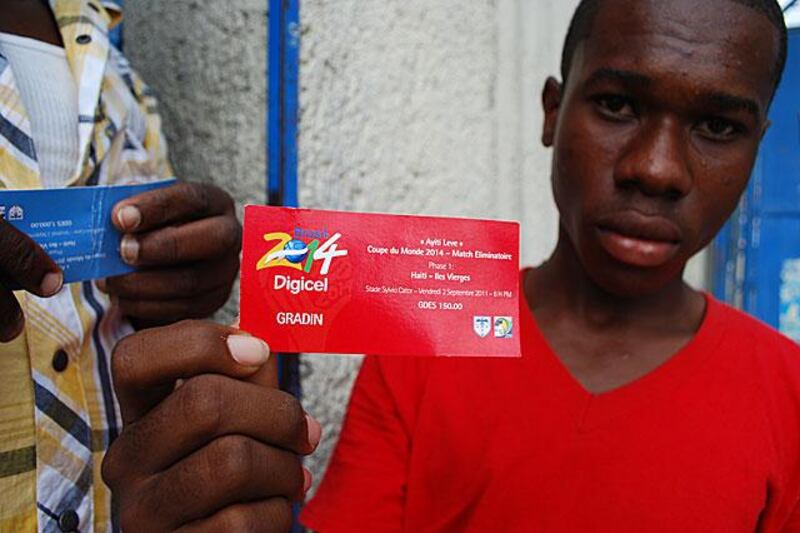 A supporter hold up his match day ticket.
