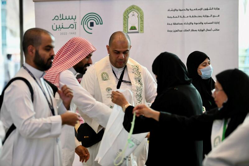 White tote bags contained specially-designed white scarves with green text and mugs, as well as other gifts.