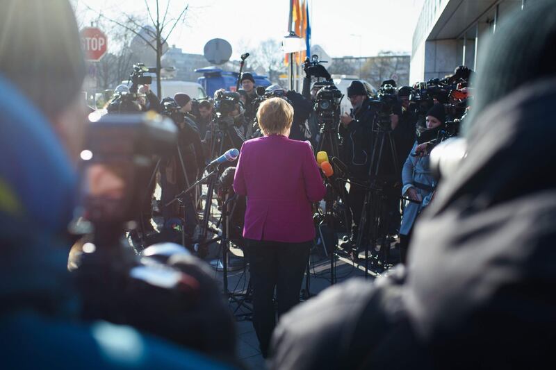German chancellor Angela Merkel, leader of the conservative Christian Democratic Union (CDU), gives a statement as she arrives for further talks to form a new government in Berlin. Gregor Fischer / AFP