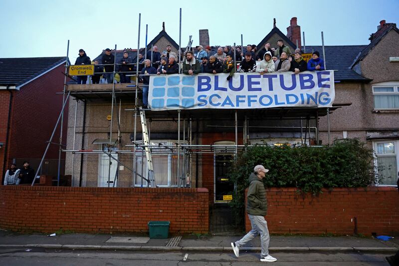 Football fans in Newport, Wales, stand on scaffolding to watch Monday's FA Cup match between Newport County and Manchester United. Reuters