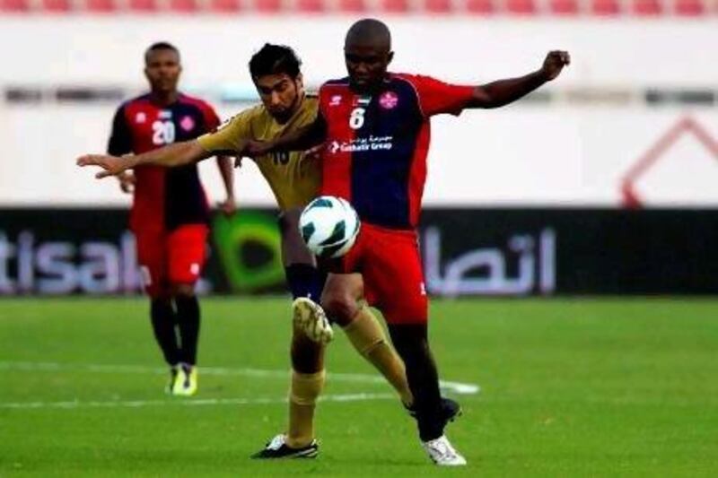 Al Shaab's Nasser Khamis battle for the ball during the first half of their Etisalat Cup. Al Shaab have made it back into the Pro League but will play their home games at Sharjah's ground.