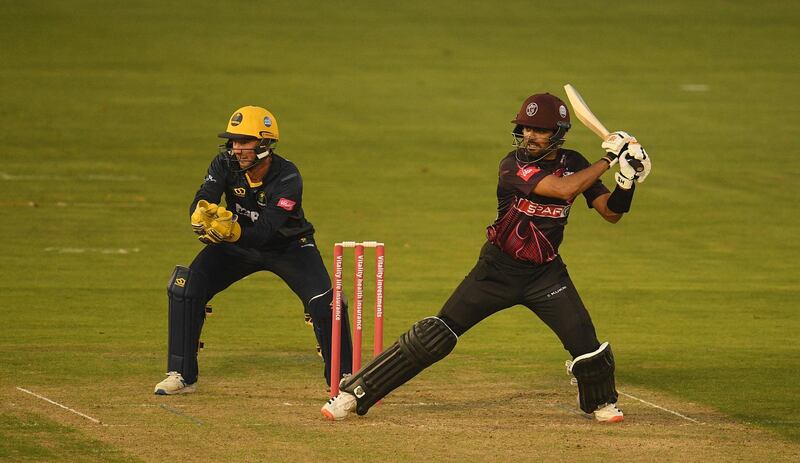Babar Azam of Somerset cuts the ball as Chris Cooke of Glamorgan looks on. Getty