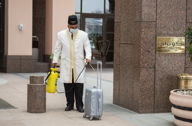 A worker sanitises a bag at Conrad Cairo hotel in the Egyptian capital after government decided to reopen the hotels.  EPA