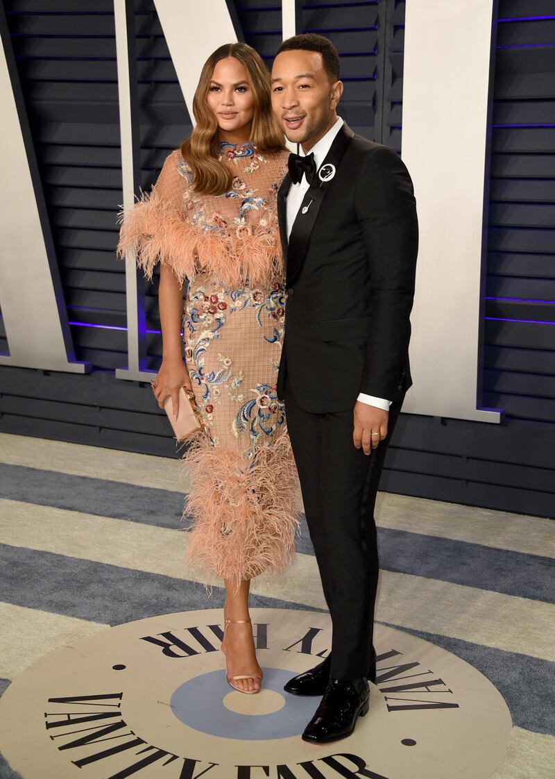Chrissy Teigen in Marchesa and John Legend arrive at the 2019 Vanity Fair Oscar Party. AP