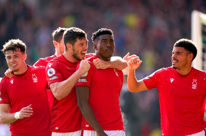 Nottingham Forest's Taiwo Awoniyi, second right, celebrates with his team-mates after scoring against Liverpool. AP