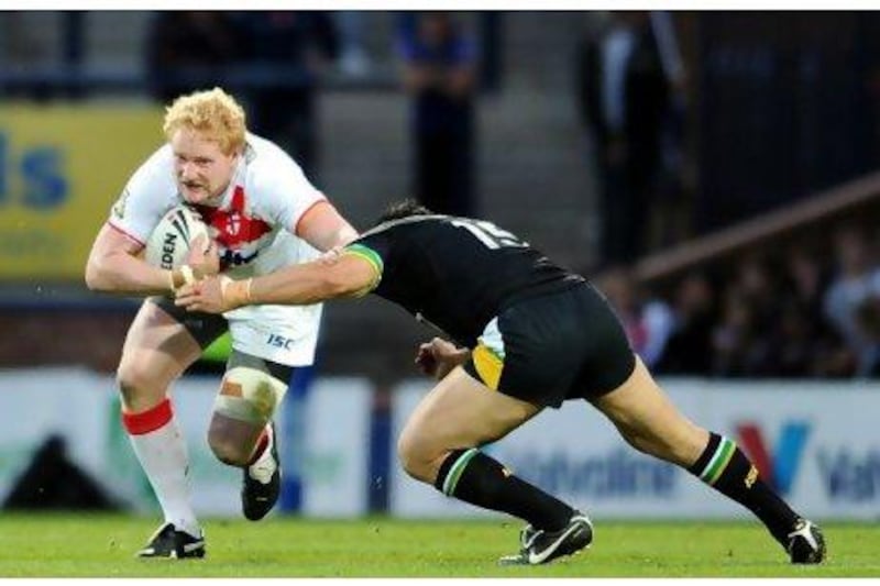 James Graham, who showed some steel for England, is tackled by Kyle Leuluai of Exiles.