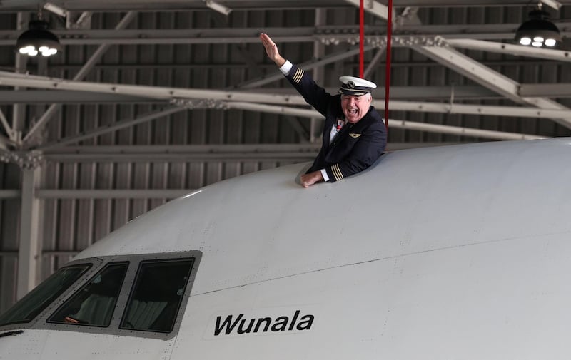 A pilot poses on a Qantas 747 jumbo jet. Reuters