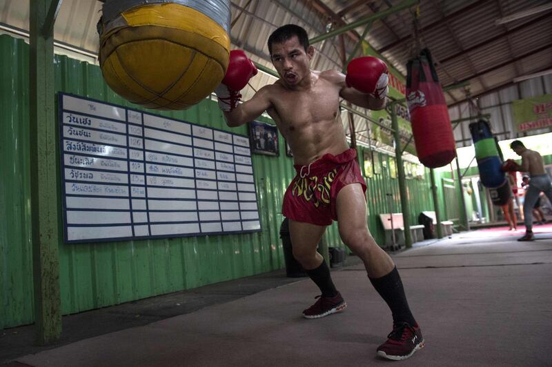 World Boxing Council (WBC) mini-flyweight champion, Wanheng Menayothin, punching a bag during a training session in Bangkok. Lillian Suwanrumpha / AFP
