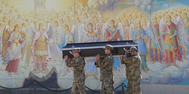 Ukrainian soldiers carry a comrade's coffin at St  Mikhailovsky Cathedral during a funeral ceremony in Kyiv, Ukraine. EPA