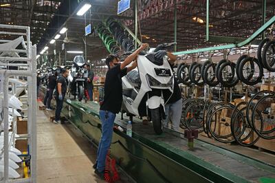 A worker works on an electric motorcycle on the assembly line in a factory in Indonesia. Bloomberg