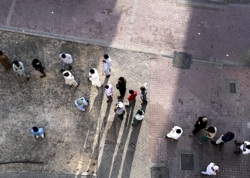 DUBAI, UNITED ARAB EMIRATES. 27 APRIL 2020. 
People line up in Bur Dubai to receive an iftar pack from volunteers of the Kerala NGO Markaz.
(Photo: Reem Mohammed/The National)

Reporter:
Section: