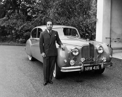 16th October 1954:  King Faisal II of Iraq (1935 - 1958) poses beside a gleaming Jaguar at Stanwell Place.  (Photo by Reg Speller/Fox Photos/Getty Images)
