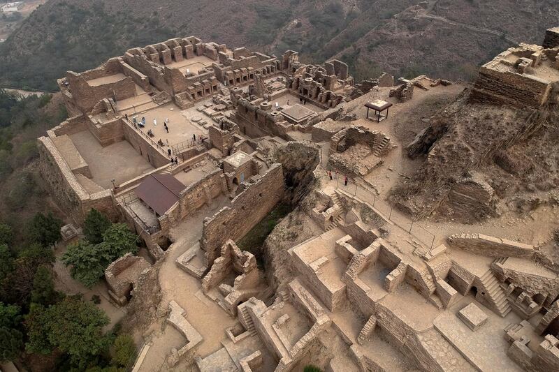 Tourists visit the Buddhist monastic complex of Takht-i-Bahi (Throne of Origins) on the crest of a hill in Mardan on February 20, 2021.  (Photo by Abdul MAJEED / AFP)