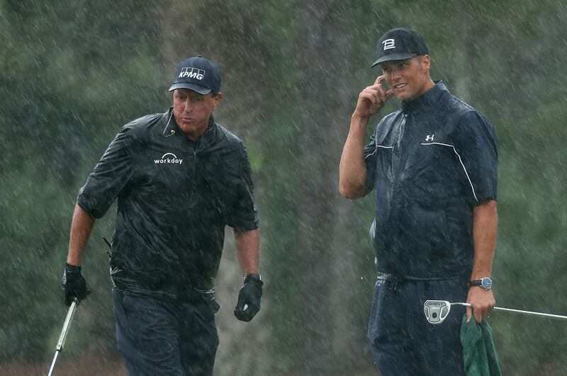 Phil Mickelson and Tom Brady on the 13th green. Getty