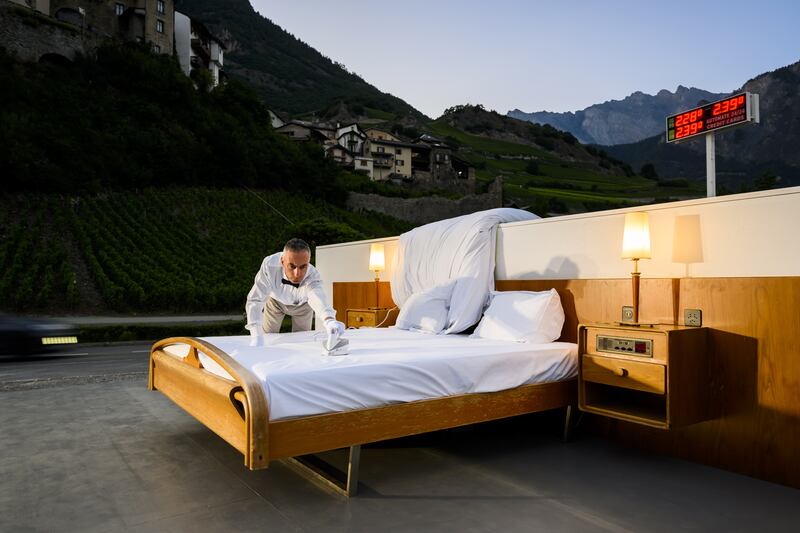 A butler irons the bed of the 'anti-idyllic' suite. 