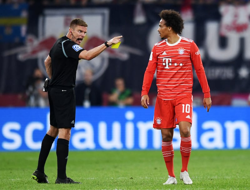 Bayern Munich's Leroy Sane is shown a yellow card by referee Robert Schroder. Reuters