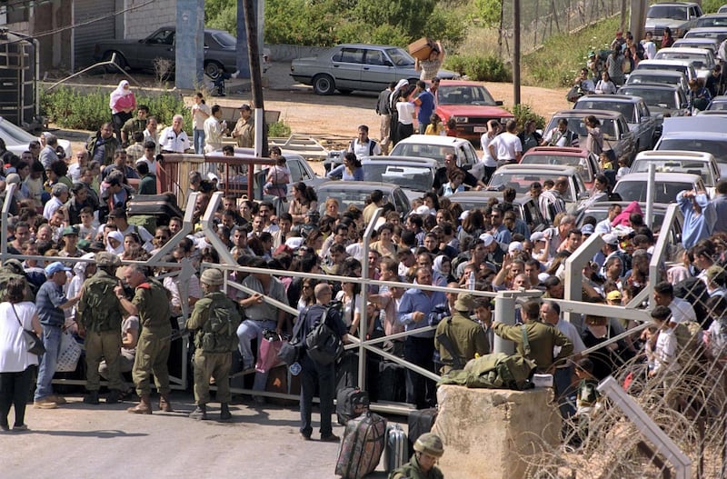 LEBANESE BORDER, ISRAEL - MAY 23, 2000: (FILE PHOTO) In this archive image provided by the Israeli Government Press Office (GPO), Lebanese refugees, many of them relatives of fighters with the South Lebanese Army, an Israeli proxy militia, wait to enter Israel after the Israeli withdrawal from Lebanon May 23, 2000 at the Fatma gate along the Israeli-Lebanese border. (Photo by Moshe Milner/GPO via Getty Images)