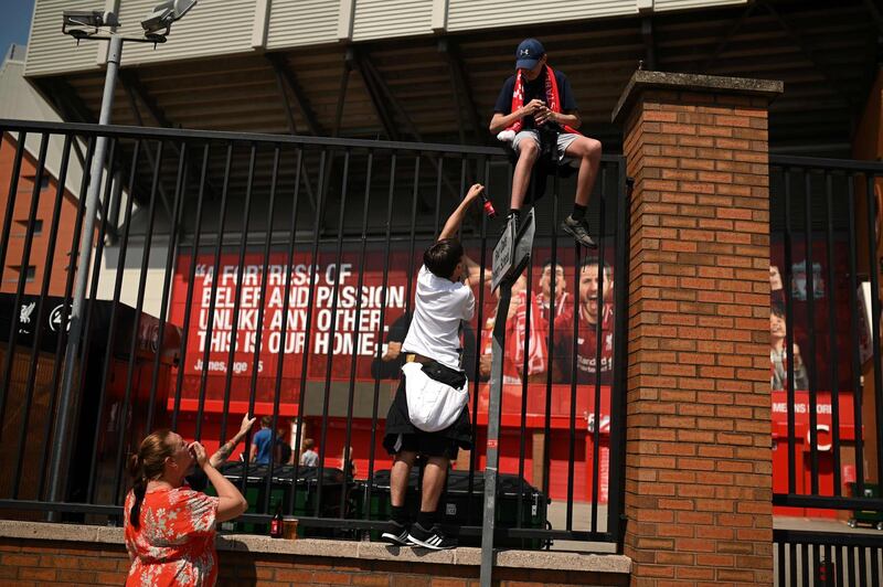 Liverpool fan gather in celebration outside Anfield stadium. AFP