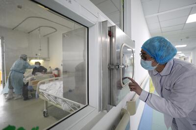 A medical worker calls his colleague inside an isolated ward at Jinyintan Hospital in Wuhan, the epicentre of the novel coronavirus outbreak, in Hubei province, China February 13, 2020. Picture taken February 13, 2020. China Daily via REUTERS  ATTENTION EDITORS - THIS IMAGE WAS PROVIDED BY A THIRD PARTY. CHINA OUT.