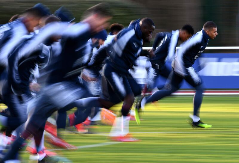 France's Kylian Mbappe and teammates run during a training session in Clairefontaine-en-Yvelines. AFP