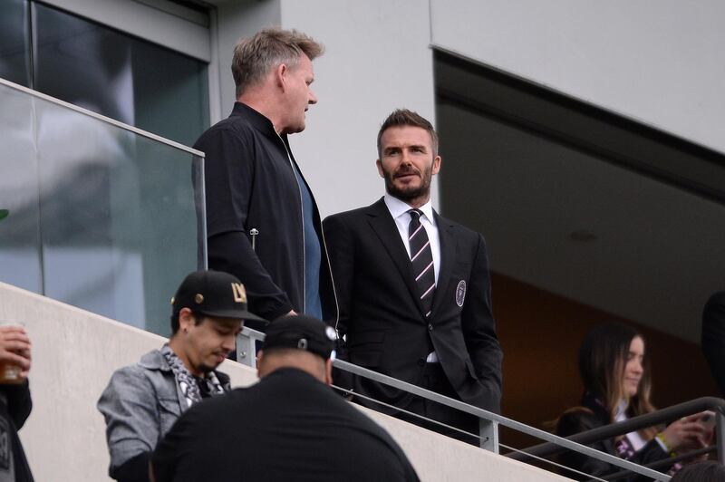 David Beckham, right, and chef Gordon Ramsay talk before the game. Reuters