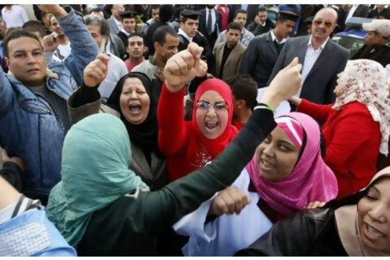 Employees of the public health sector shout slogans as they rally in Cairo yesterday to demand better wages and working conditions.