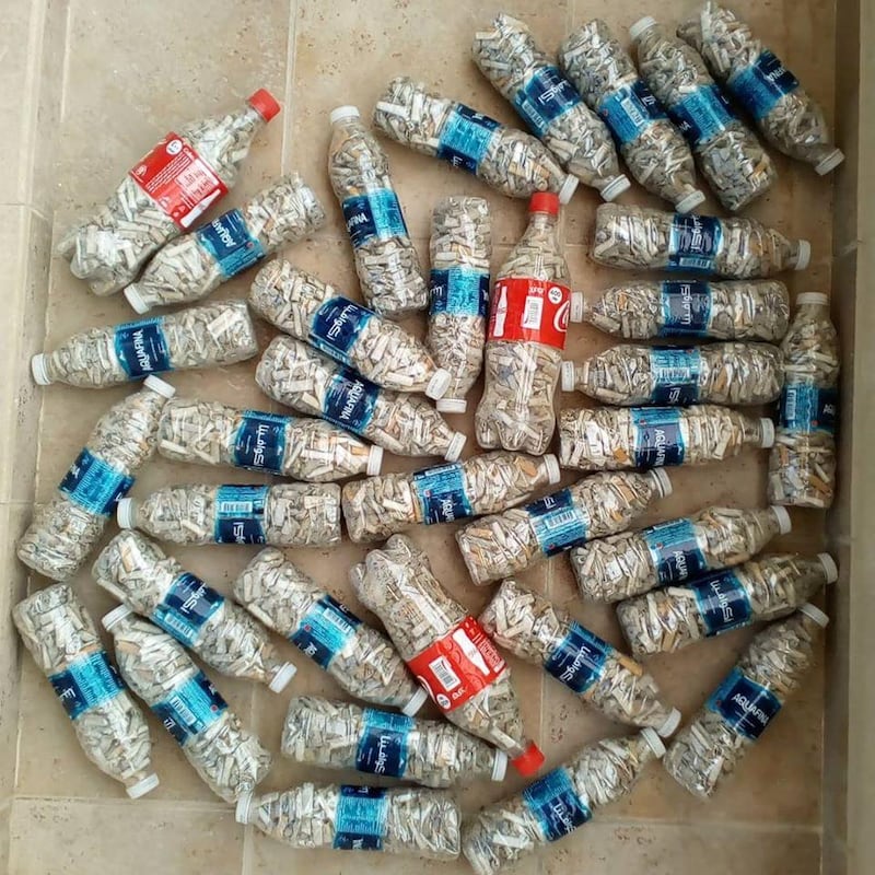 Bahrain resident Kai Miethig using 600-millilitre plastic bottles to collect more than 7,600 cigarette butts. Courtesy Kai Miethig