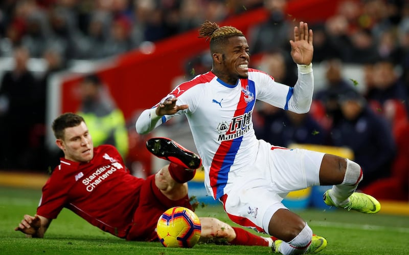 Soccer Football - Premier League - Liverpool v Crystal Palace - Anfield, Liverpool, Britain - January 19, 2019  Crystal Palace's Wilfried Zaha in action with Liverpool's James Milner   Action Images via Reuters/Jason Cairnduff  EDITORIAL USE ONLY. No use with unauthorized audio, video, data, fixture lists, club/league logos or "live" services. Online in-match use limited to 75 images, no video emulation. No use in betting, games or single club/league/player publications.  Please contact your account representative for further details.