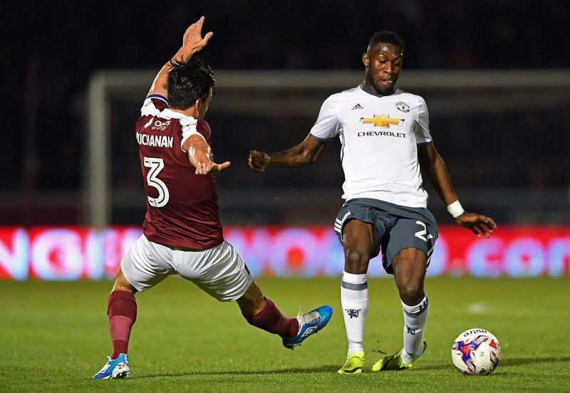 Timothy Fosu-Mensah of Manchester United and David Buchanan of Northampton Town in action. Shaun Botterill / Getty Images