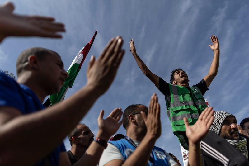 Volunteers and NGO staff at Rafah celebrate as the first 20 aid lorries start to cross into Gaza, which has been shattered by Israeli air strikes. Getty Images
