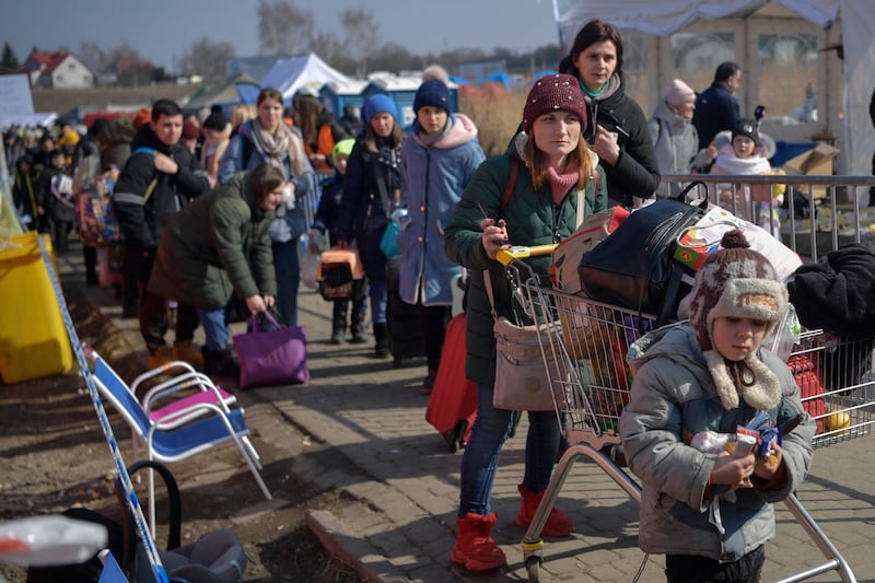 Refugees wait for transport In Medyka, Poland, after crossing the Ukrainian border. AFP