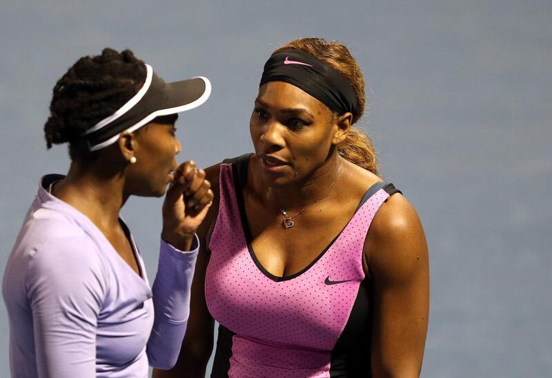 Venus Williams, left, and younger sister Serena fell a little short as doubles partners earlier this week in Dubai. They could find themselves on opposite sides of the net in Saturday’s singles final. Warren Little / Getty Images

