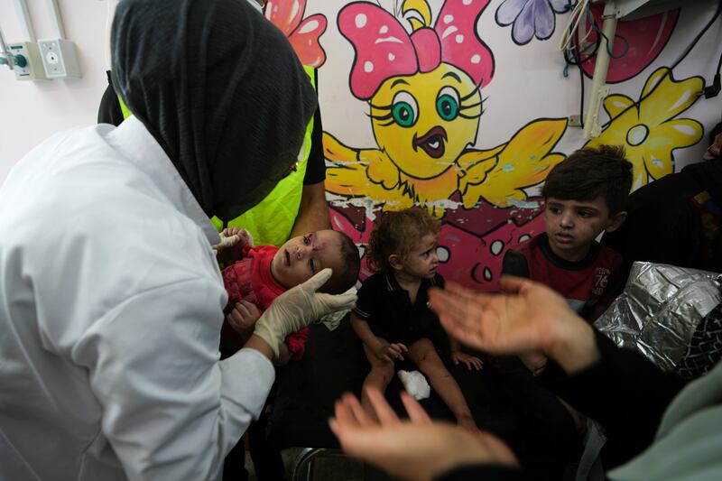 Palestinian children wounded in Israeli air strikes are brought to Al Aqsa hospital in Deir El Balah, Gaza. AP