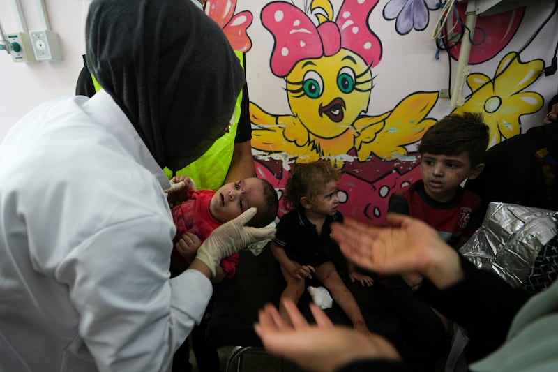 Palestinian children wounded in Israeli air strikes are brought to Al Aqsa hospital in Deir El Balah, Gaza. AP