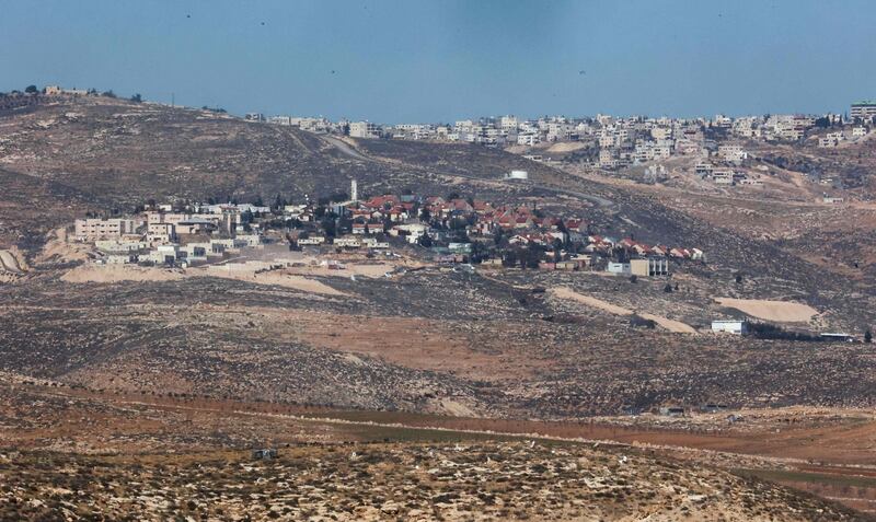 A picture shos a view of the Israeli settlement of Beni Hever, with the Palestinian Bani Naim village on a hill further, near Yatta south of Hebron city in the occupied West Bank. AFP